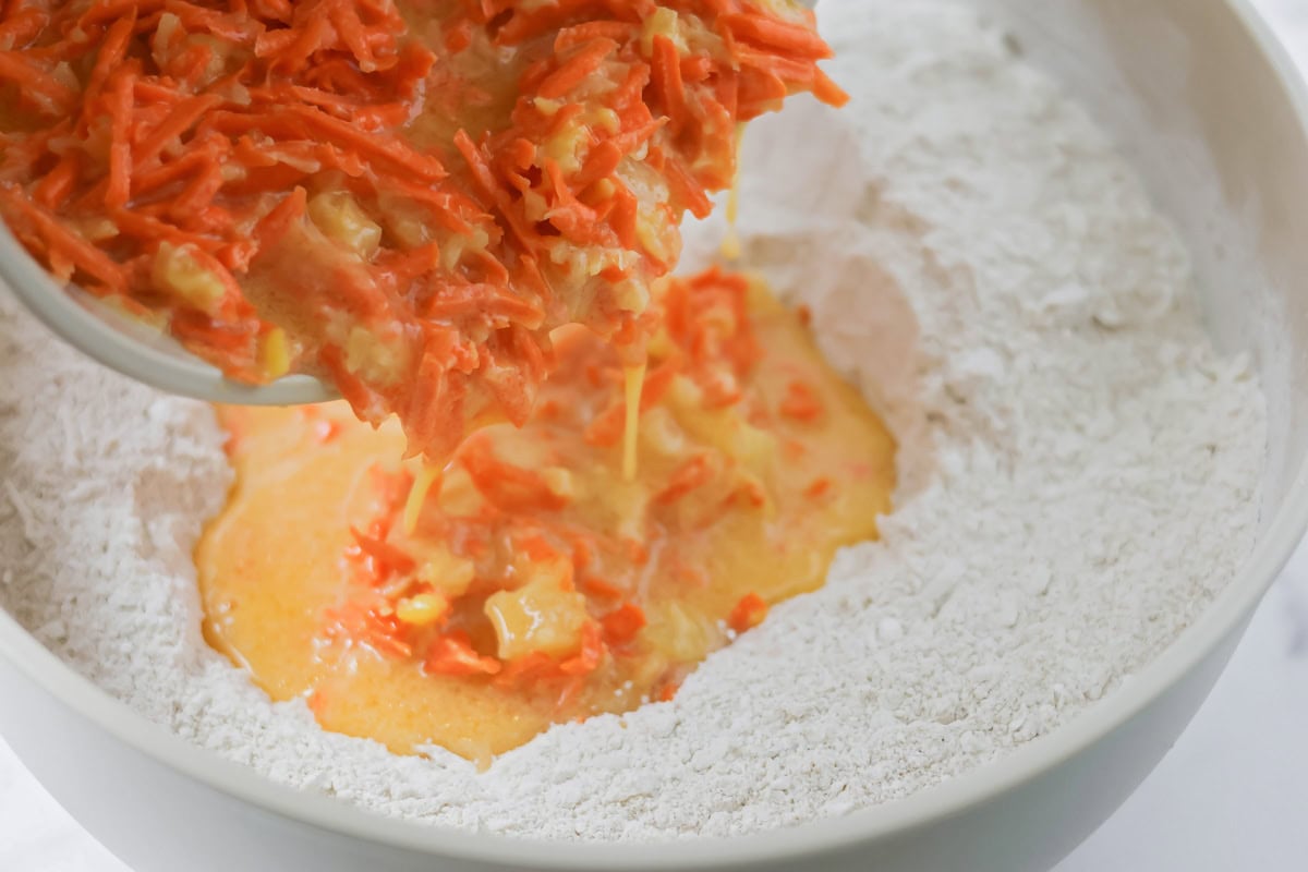 Wet ingredients being poured into dry ingredients.