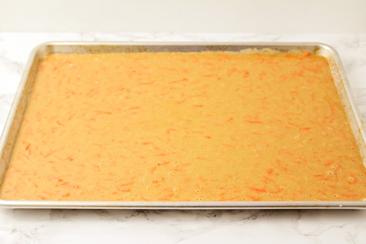 Carrot sheet cake batter poured into a sheet cake pan.