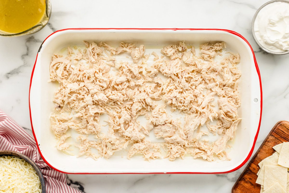 Shredded cheese on the bottom of a casserole dish.