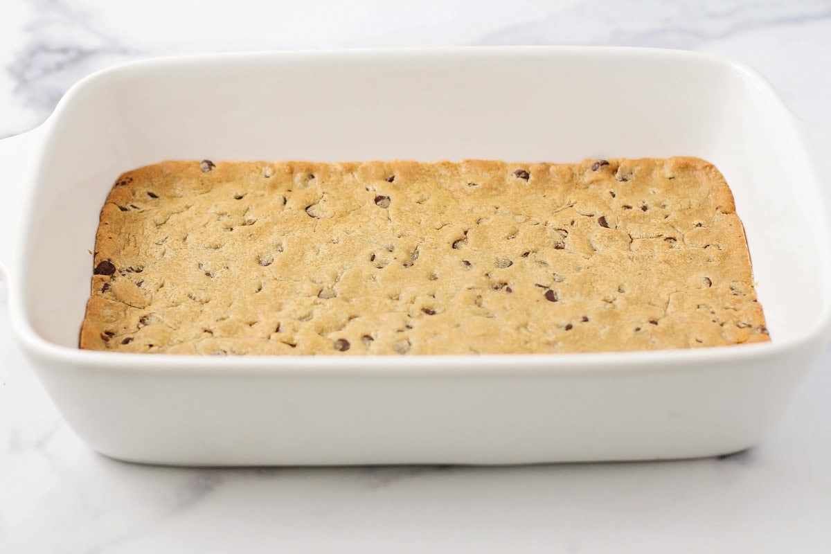 Baked cookie dough in a white baking dish.