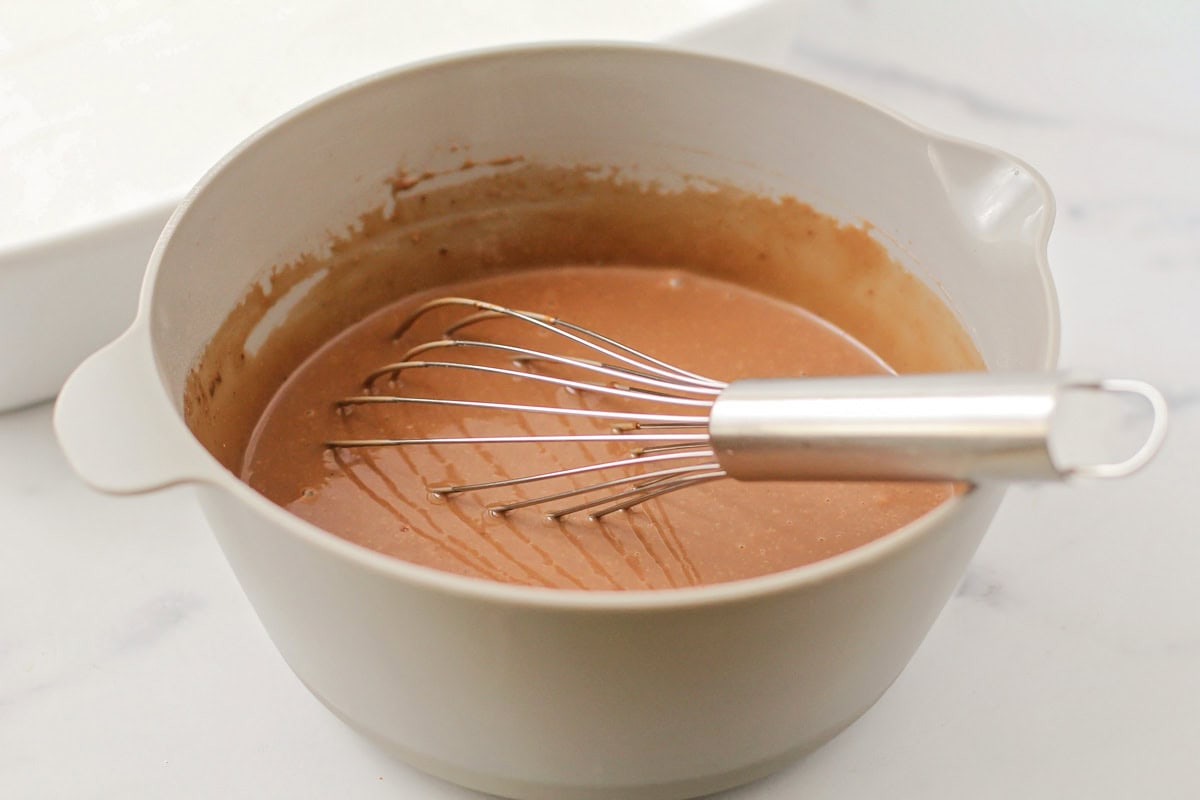 Whipping instant chocolate pudding in a gray bowl.