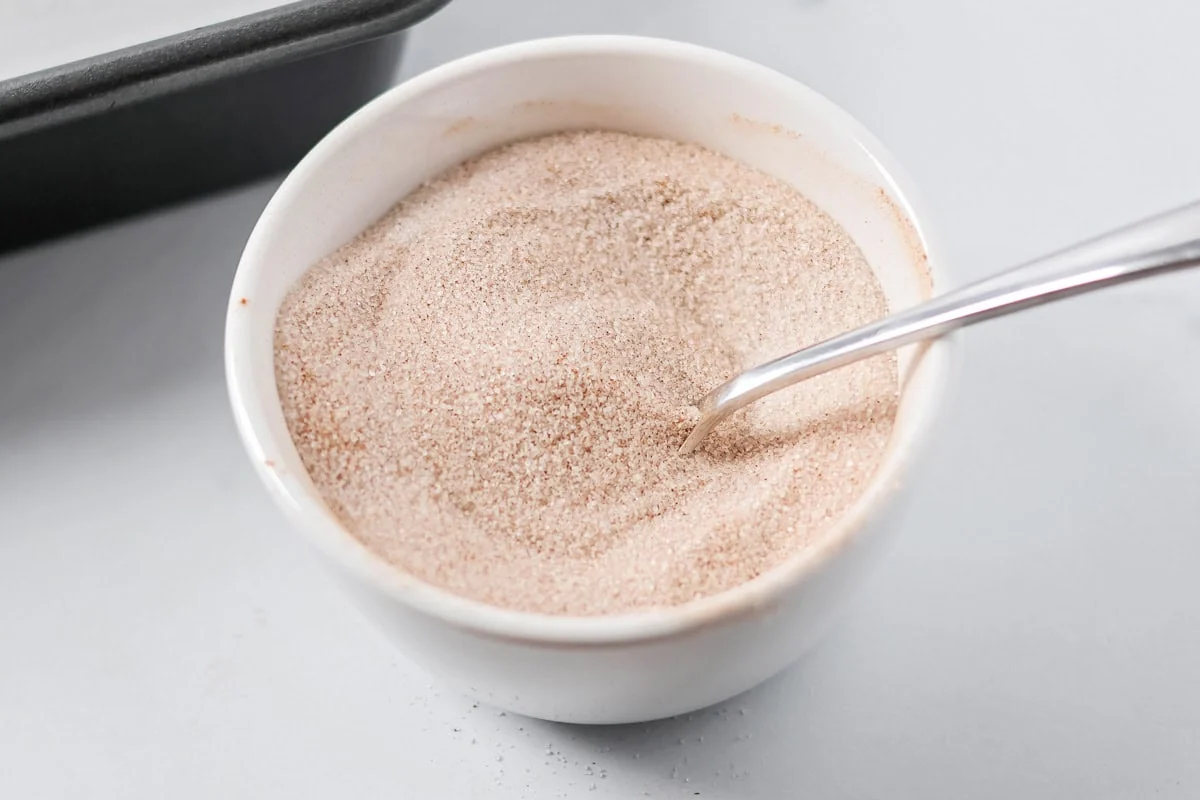 Cinnamon and sugar mixed in a bowl.
