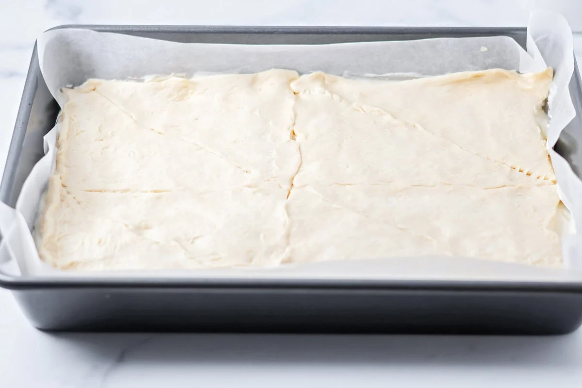 Adding another layer of crescent dough to the top.
