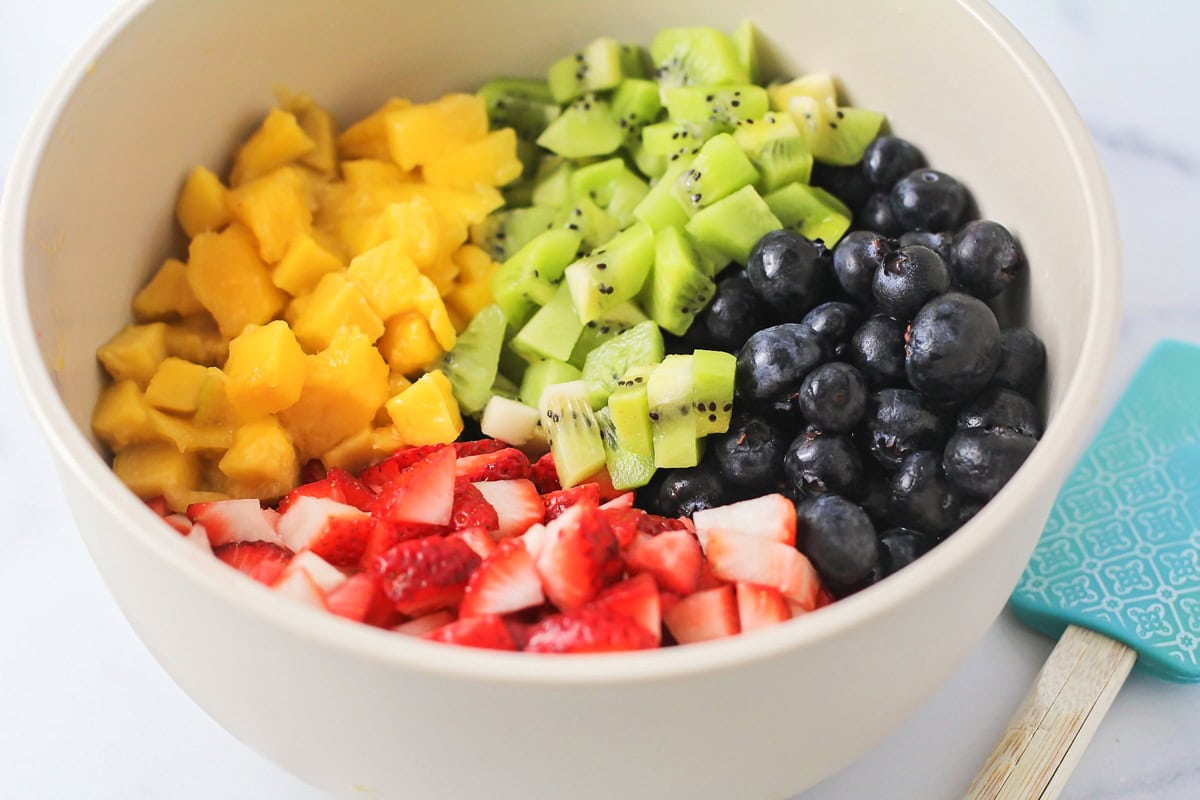 Fresh fruit salsa is a perfect pairing for our sweet homemade cinnamon chips. Ready in under 20 minutes, you can make it for any occasion! A bowl of diced fruit.