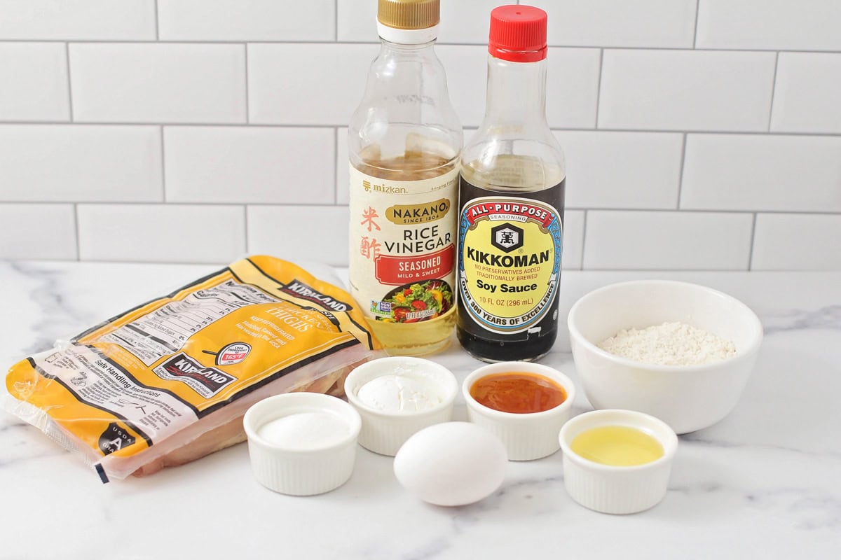 Chicken and seasonings on a kitchen counter.