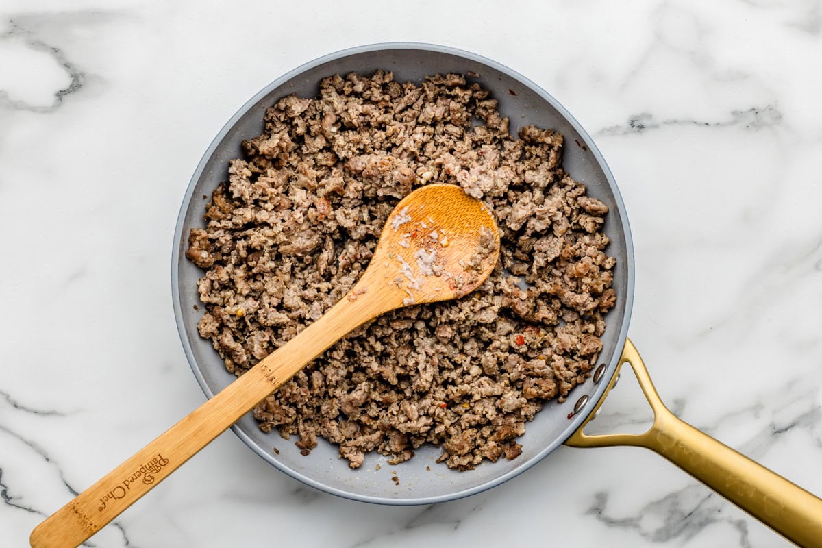 Browning sausage in a skillet.