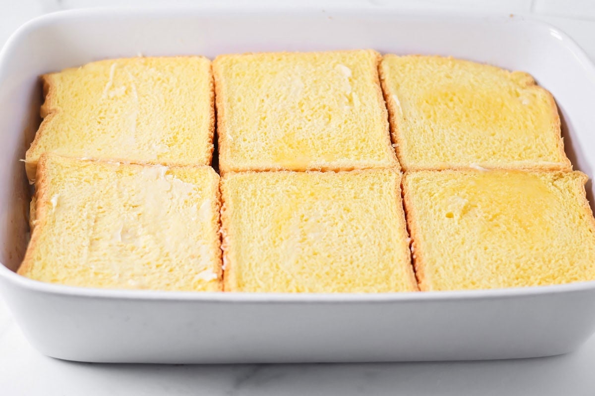 Repeating the layers with more bread.