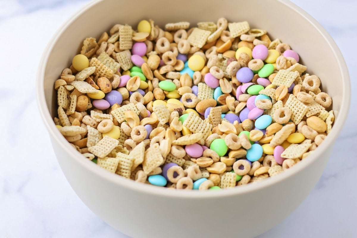 Cereal, nuts, pretzels, and M&Ms all mixed in a bowl.