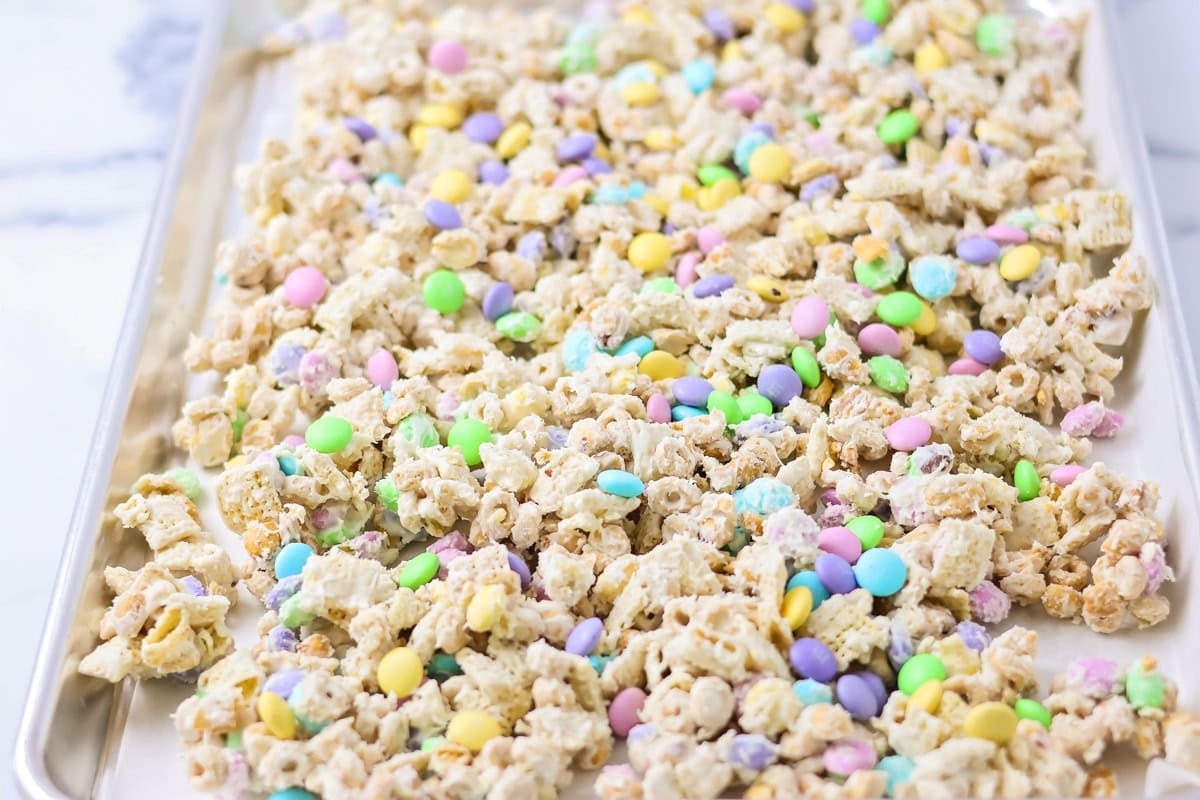 The cereal mixture spread onto a lined baking sheet to cool.