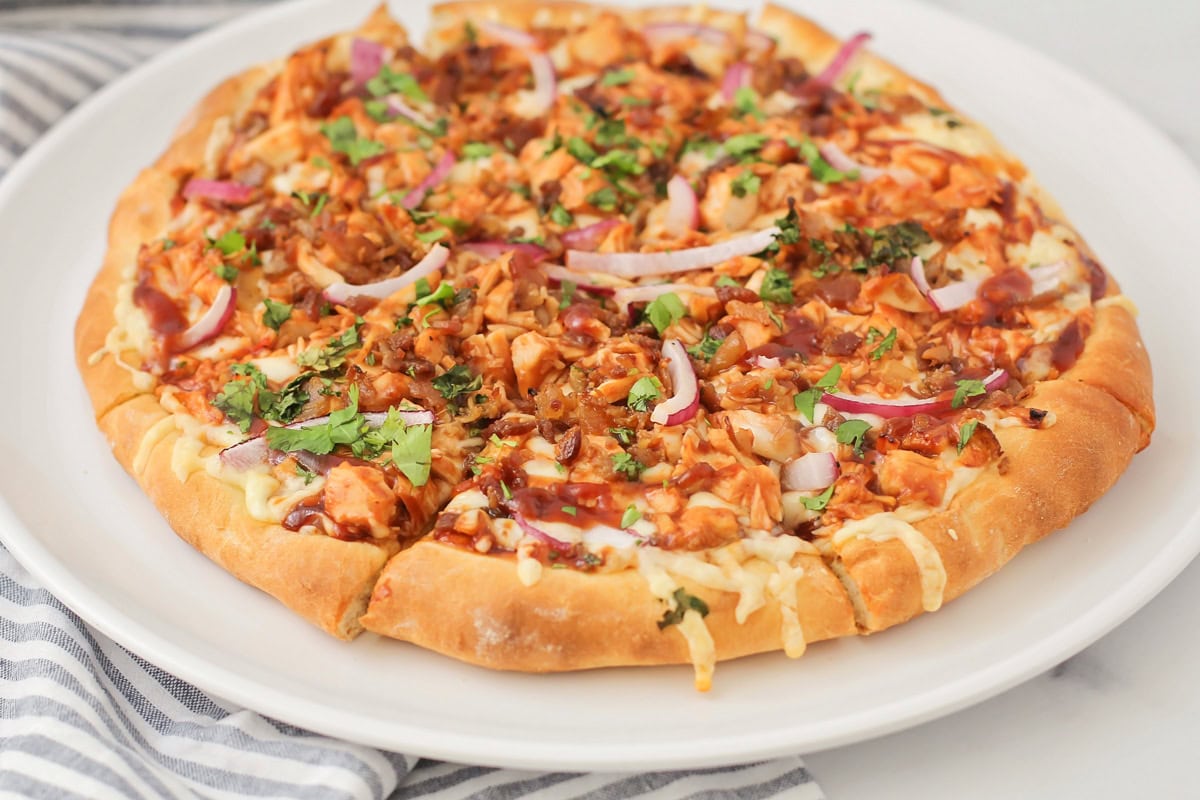 BBQ chicken pizza recipe on a white plate.