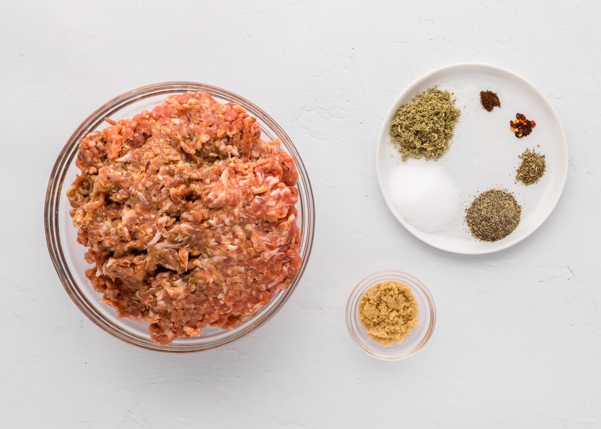 This easy breakfast sausage recipe is ready in 15 minutes and will taste 100% better than anything you'll find at the grocery store! Sausage and seasonings on a kitchen counter.