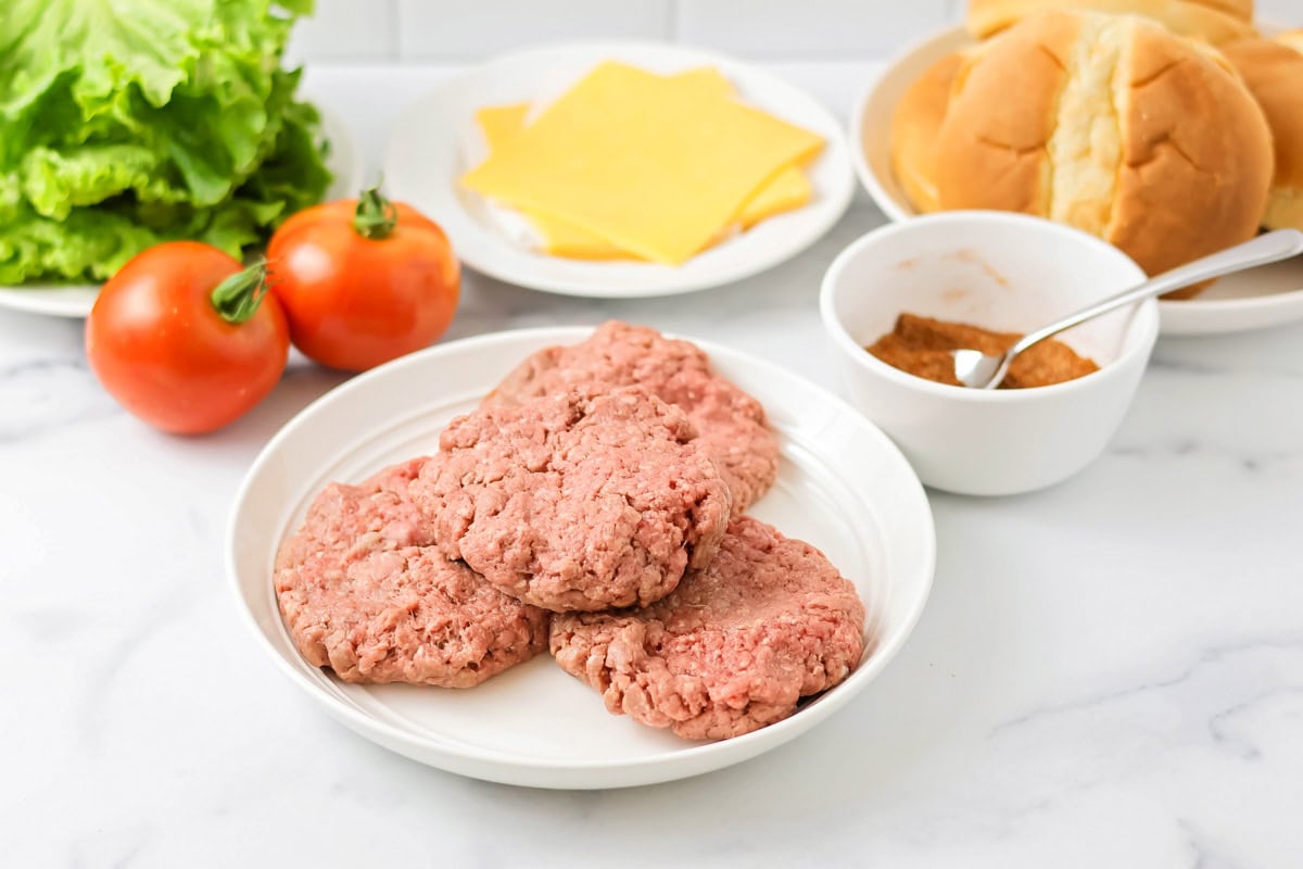 Burgers in the oven ingredients on a kitchen counter.