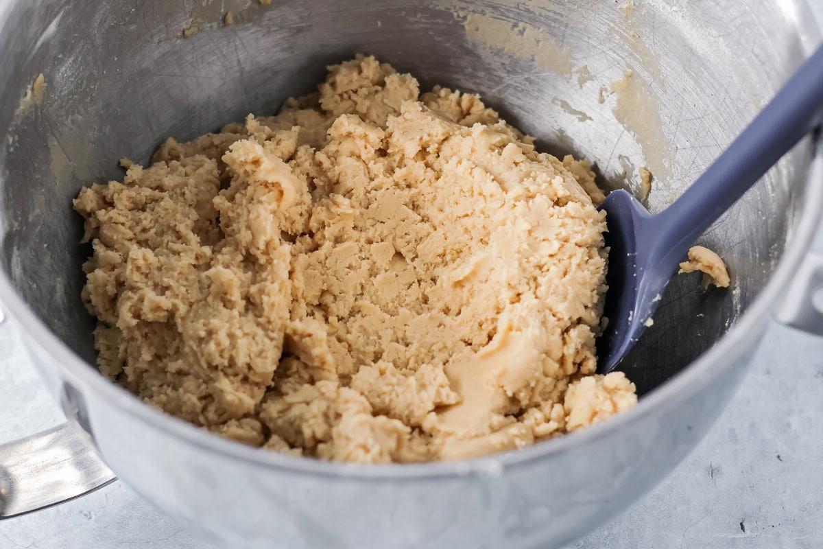 Cookie dough in a metal bowl.