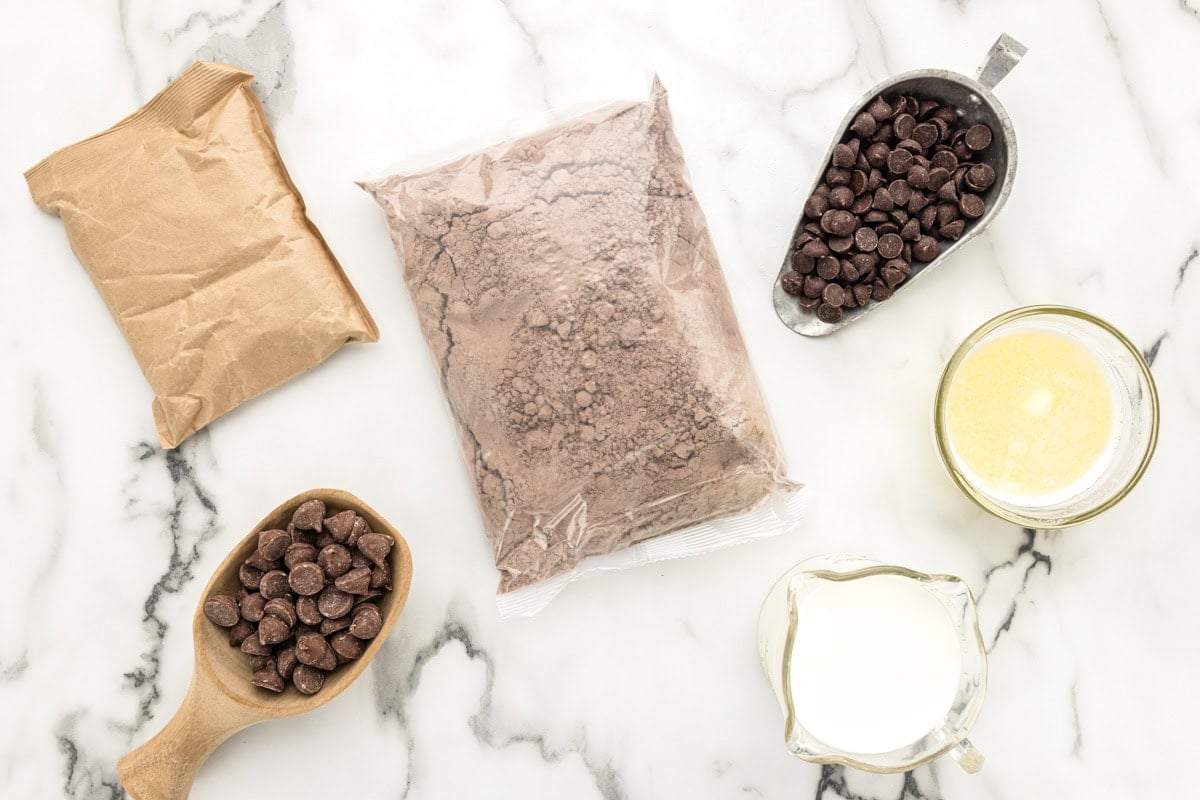 This ridiculously easy chocolate dump cake is made in one pan with just a few ingredients for the ultimate extra-chocolatey dessert! Ingredients for chocolate dump cake on a kitchen counter.