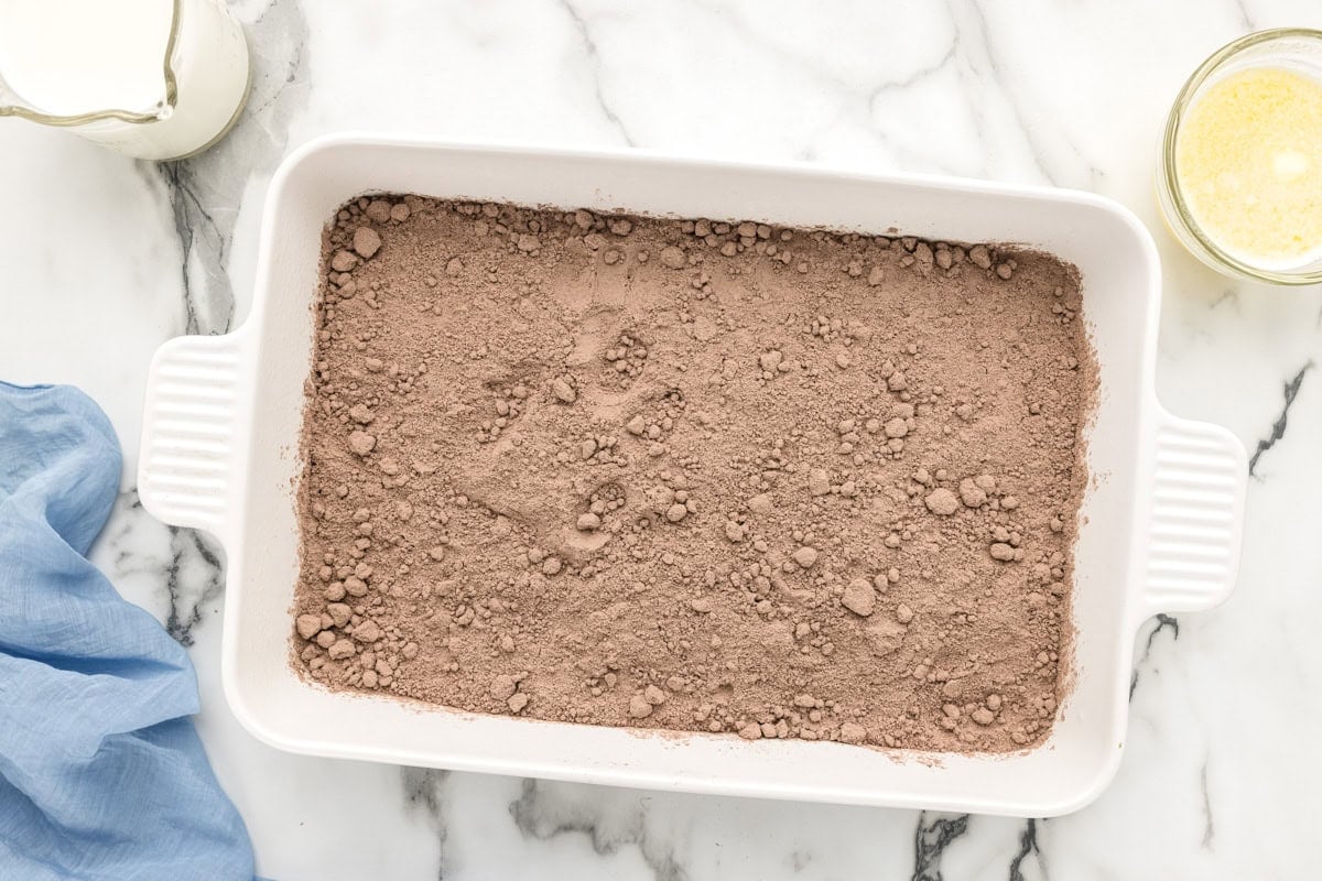 Cake mix and pudding mix powder in a baking dish.