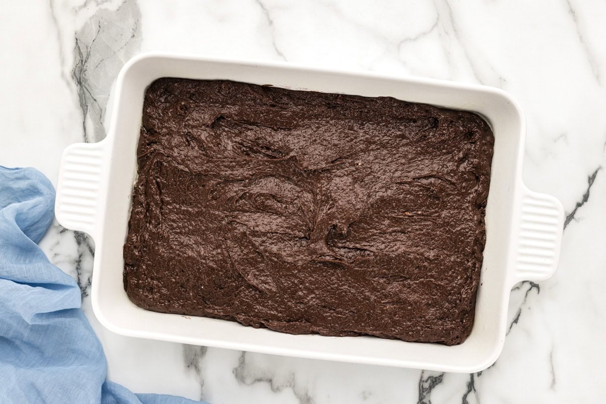 Chocolate cake batter in a baking dish.