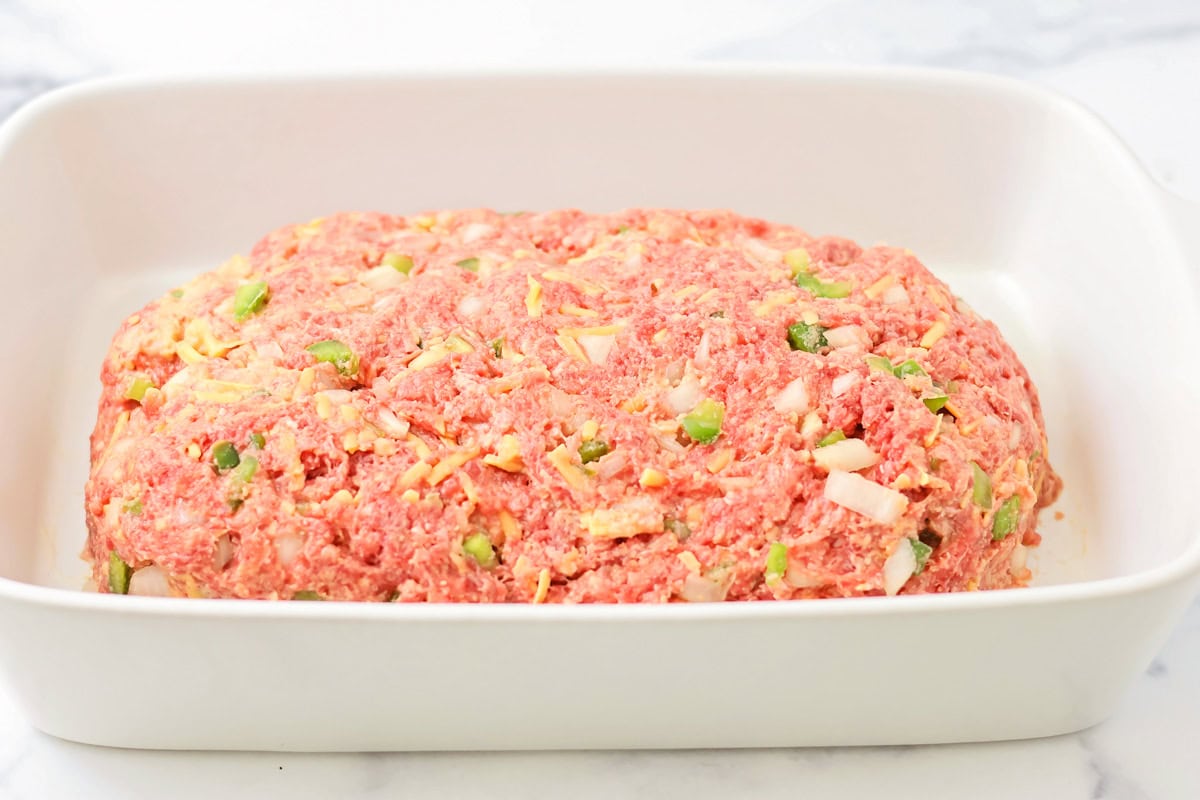 A shaped loaf of meat in a baking dish.