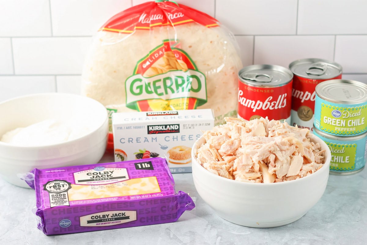 Extra creamy chicken enchiladas prep in 10 minutes with simple ingredients for a freezer-friendly, easy weeknight favorite! Ingredients for creamy chicken enchiladas on a kitchen counter.