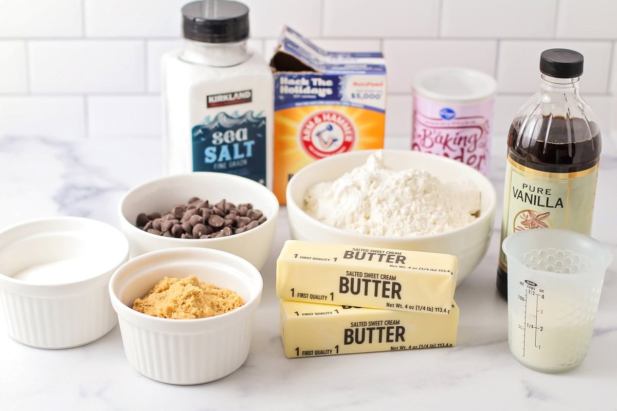 Ingredients for eggless chocolate chip cookies on a kitchen counter.