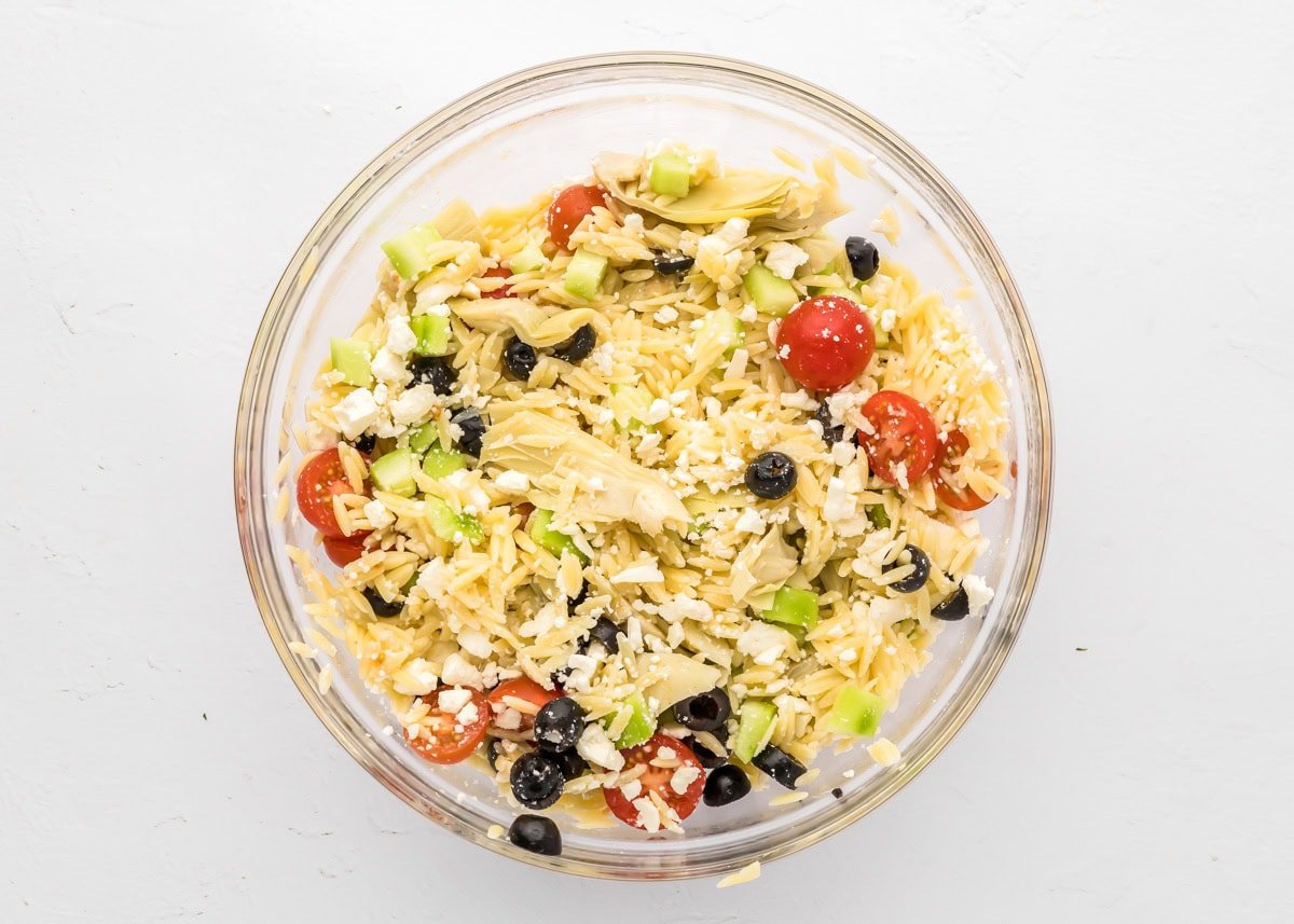 Adding pasta to the veggies.