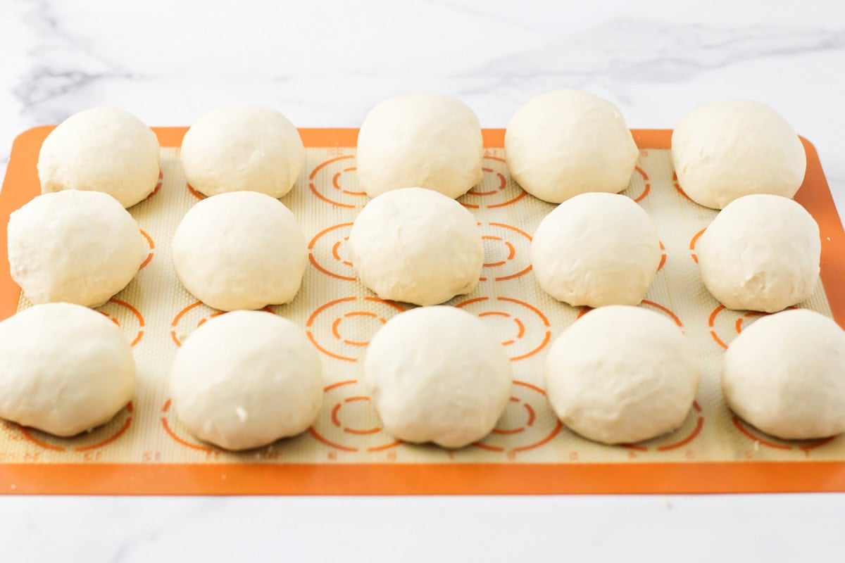 Dough shaped into balls on a silpat mat.