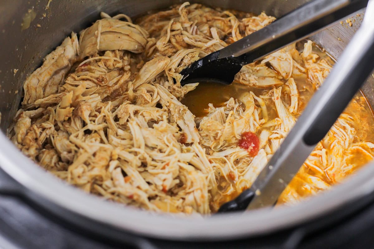 Shredded chicken in juices for instant pot chicken tacos.