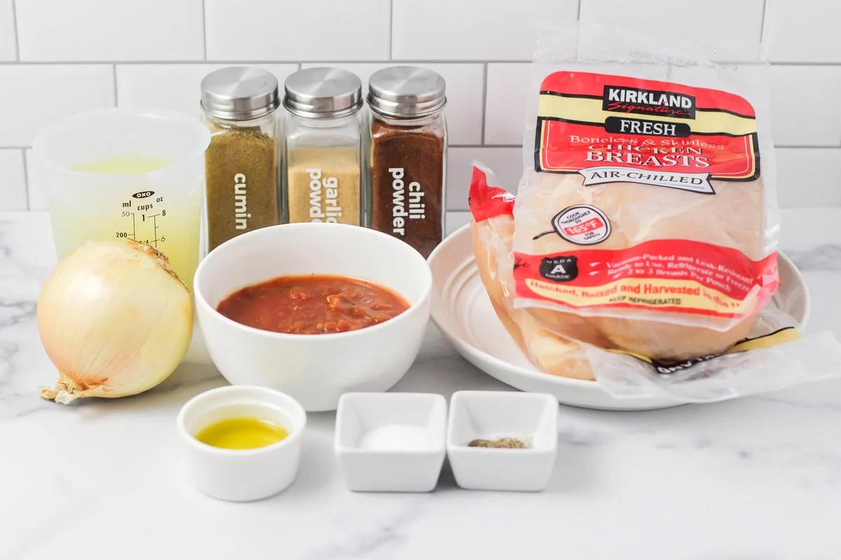 Whip up flavorful, tender instant pot chicken tacos in under 30 minutes for a quick and delicious weeknight fiesta! Ingredients for instant pot chicken tacos on a kitchen counter.