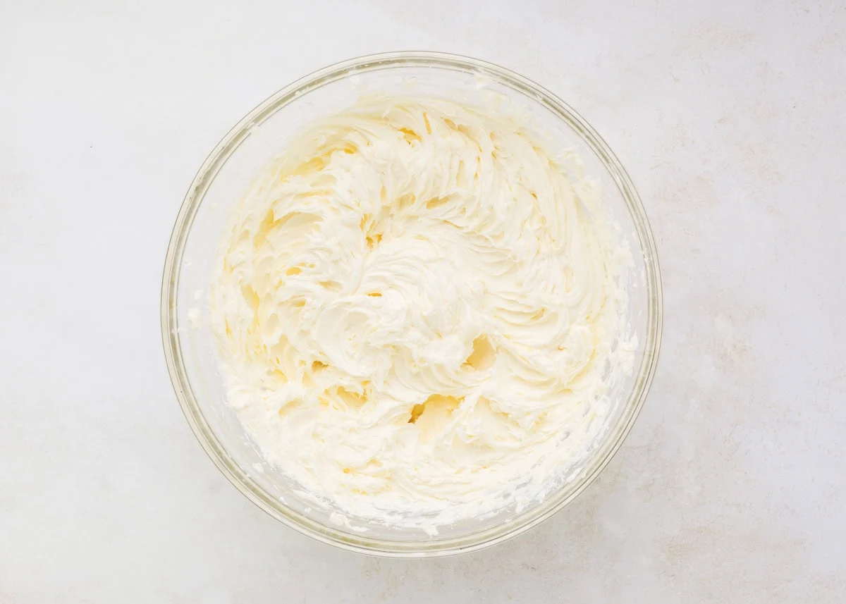 Whipped cream cheese mixture in a glass bowl.