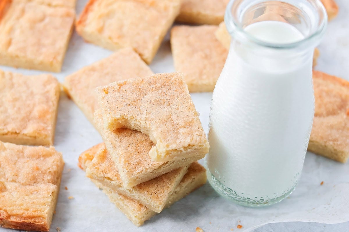 Cut snickerdoodle blondies on a kitchen counter.