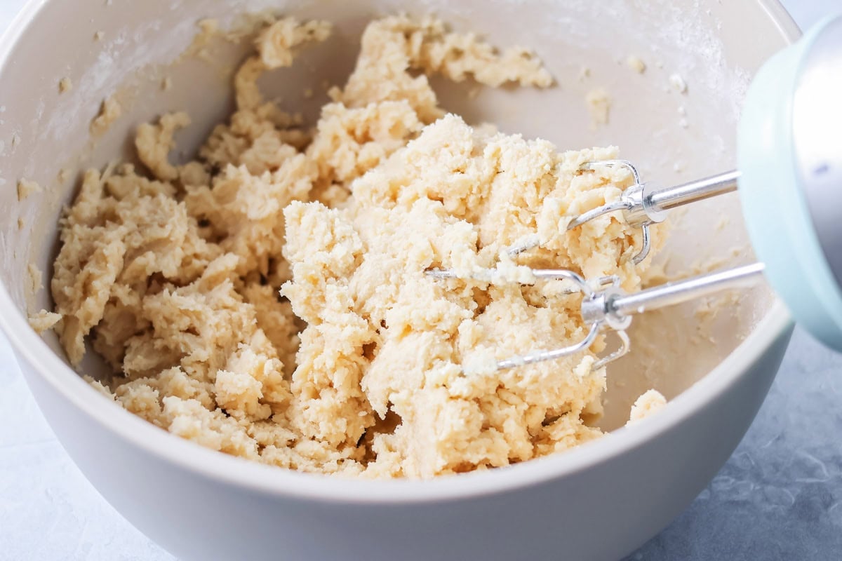 Mixing batter in a gray bowl.