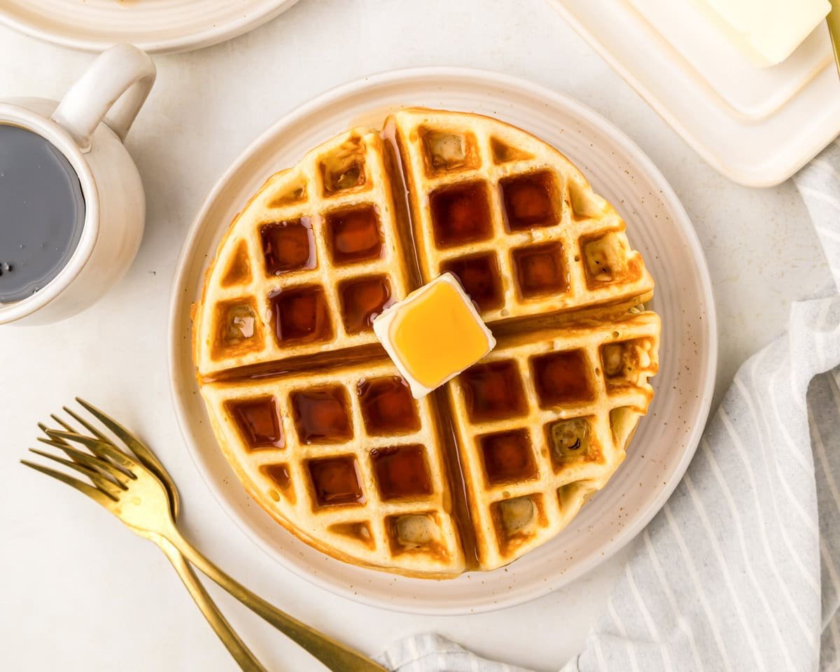 Waffle mix recipe topped with syrup and a pat of butter.