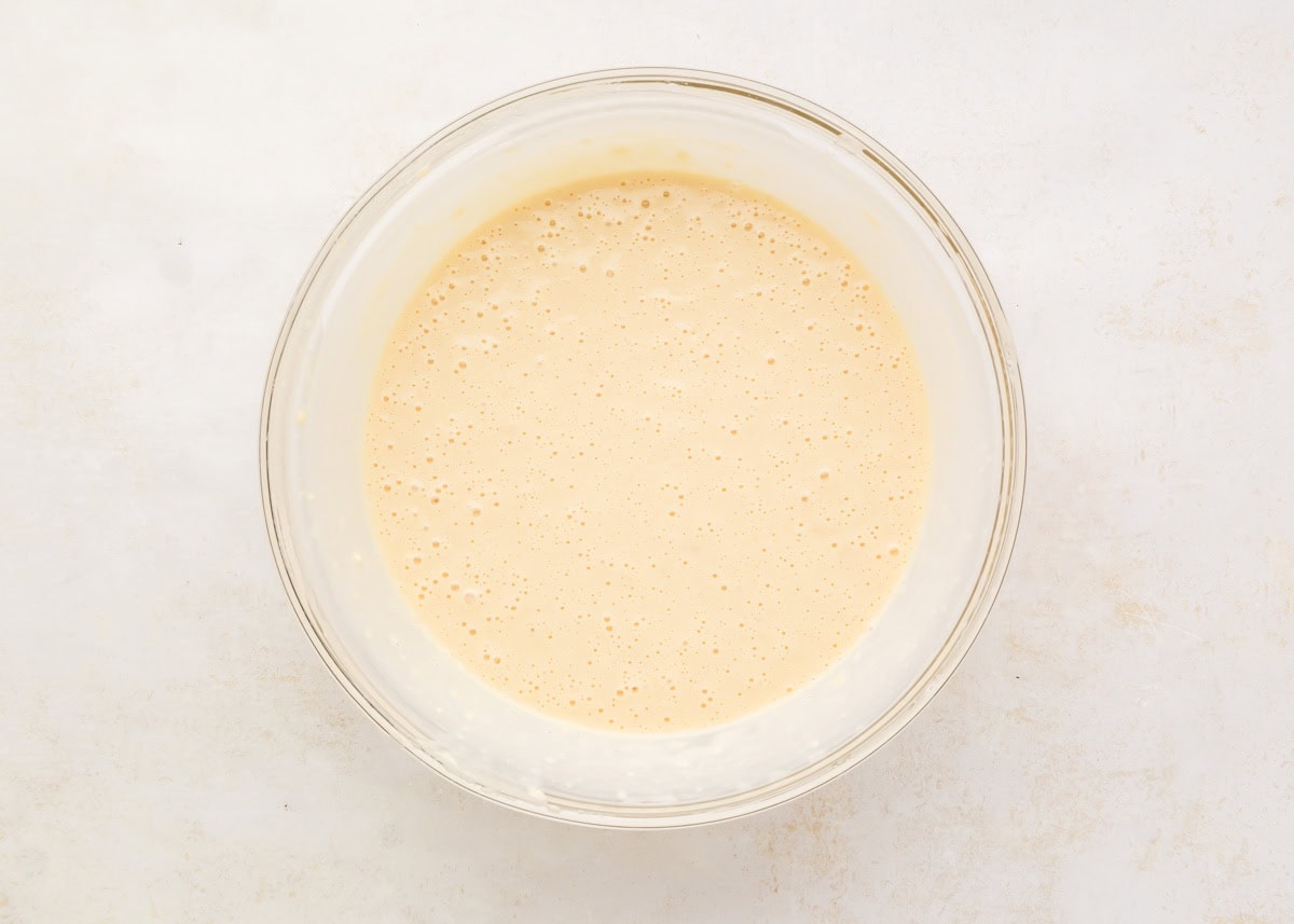 Waffle batter in a glass bowl.