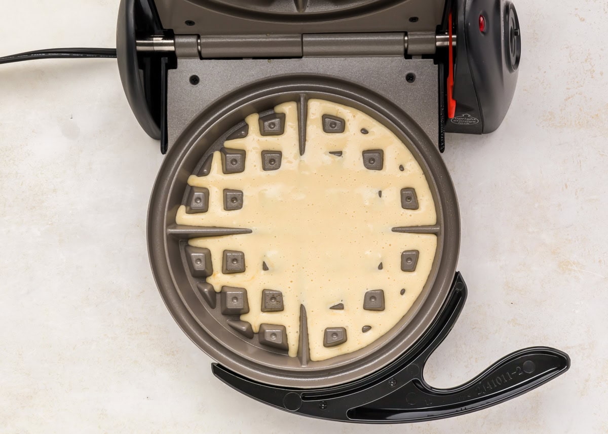 Batter poured into a waffle iron.