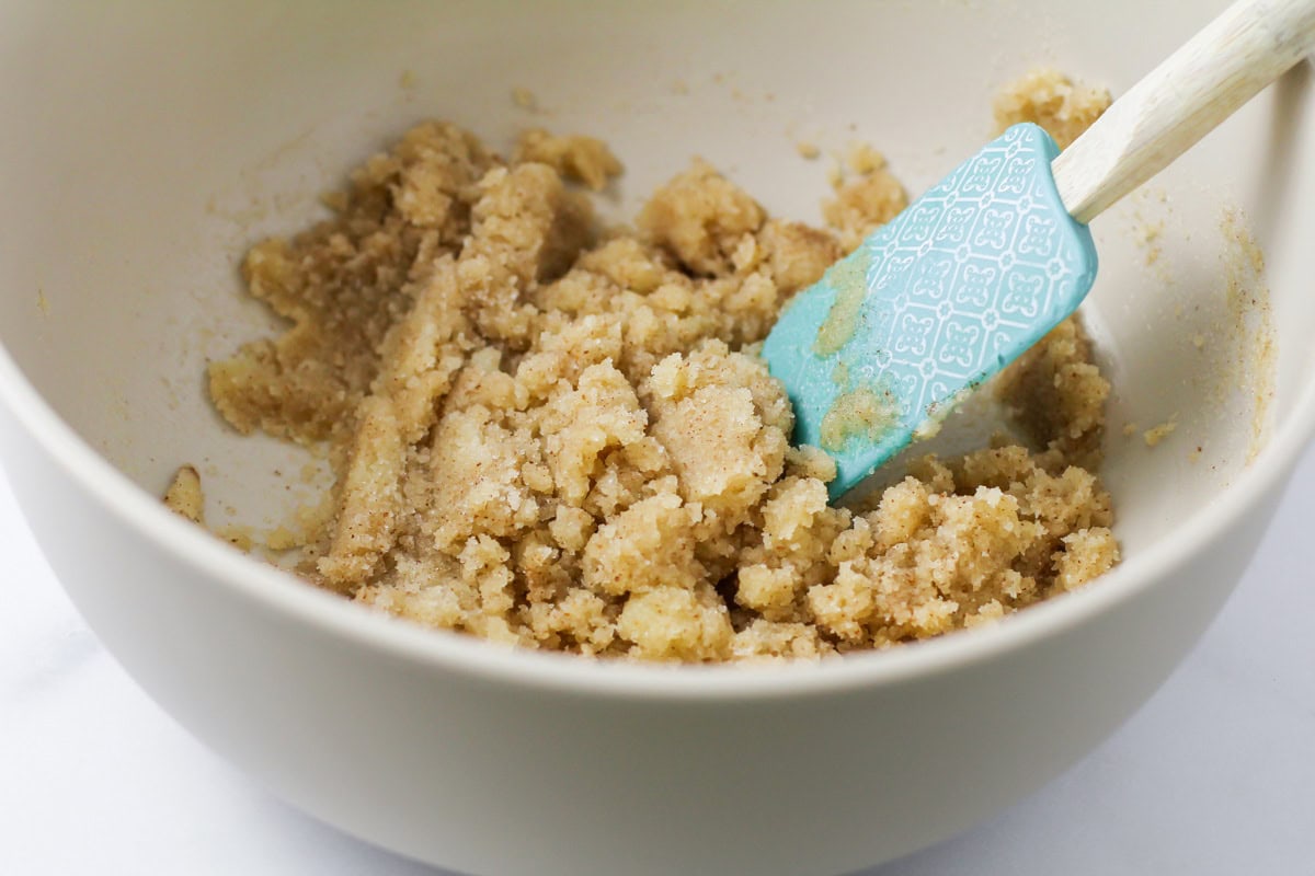 Mixing brown butter and sugar in a bowl.