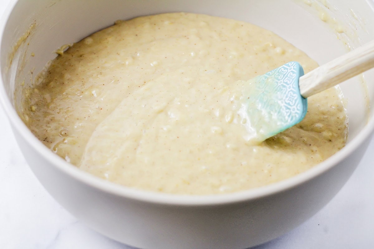 Banana bread batter in a gray bowl.