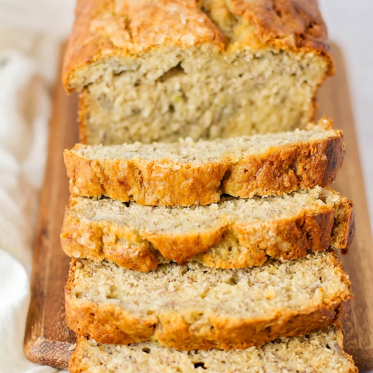 Close up of slices of brown butter banana bread on a cutting board.