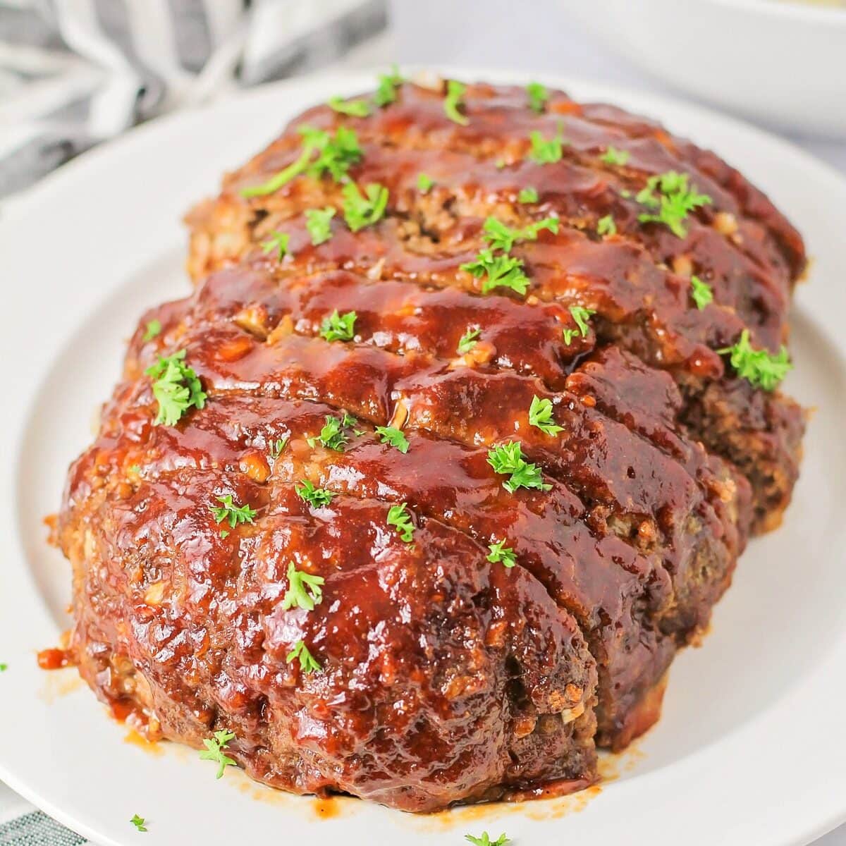 Close up image of easy meatloaf recipe with fresh parsley on top.
