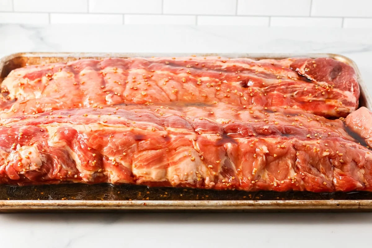 Ribs marinating on a pan.