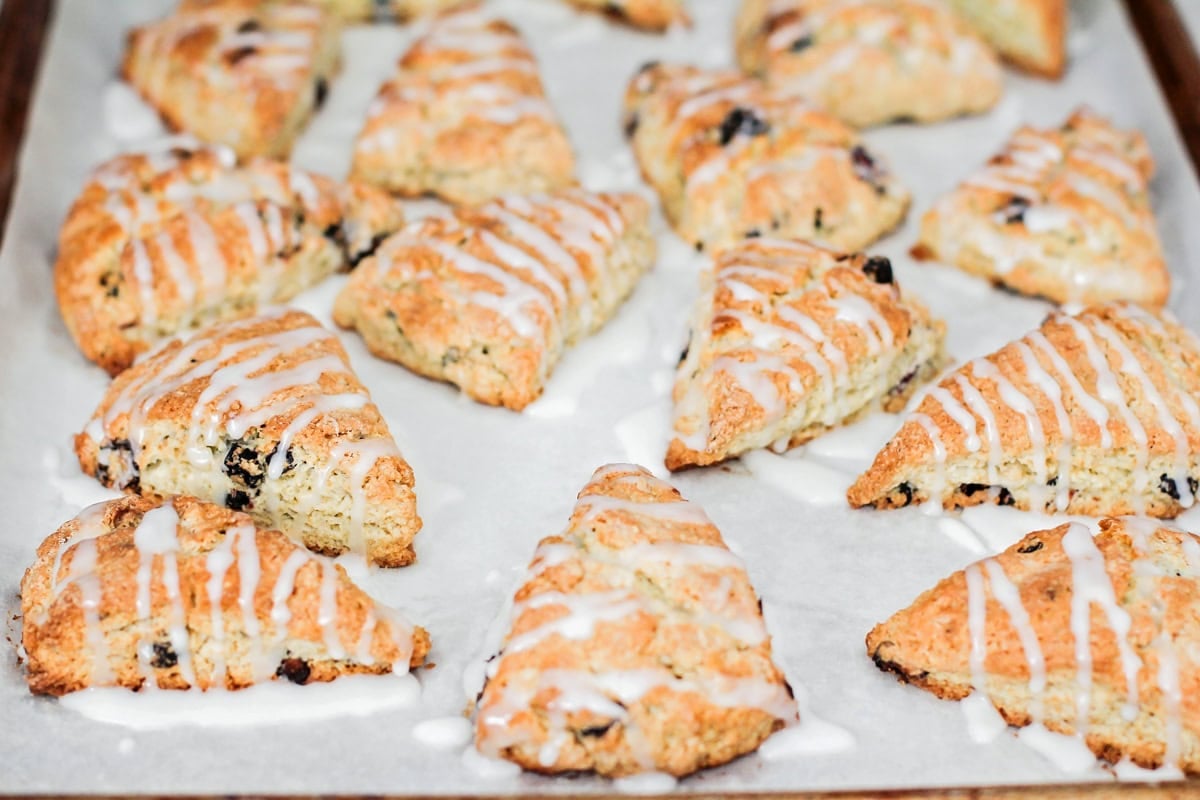 Baked scones drizzled with lemon glaze.