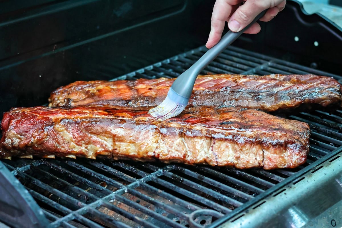Basting ribs while grilling.