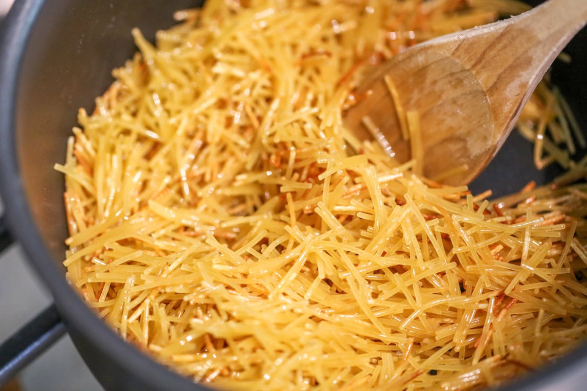 Close up image of fideo noodles being cooked in pot for sopa de fideo.