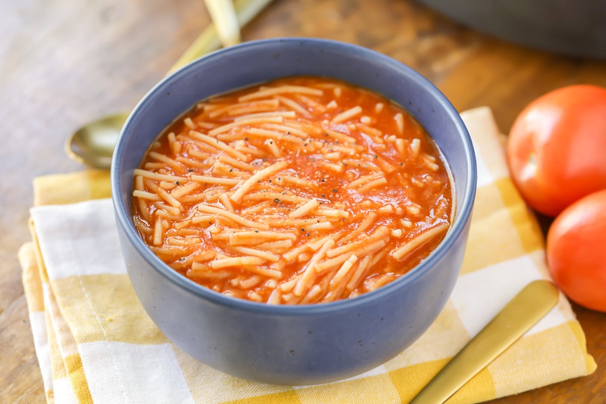 Close up image of sopa de fideo in blue bowl. 