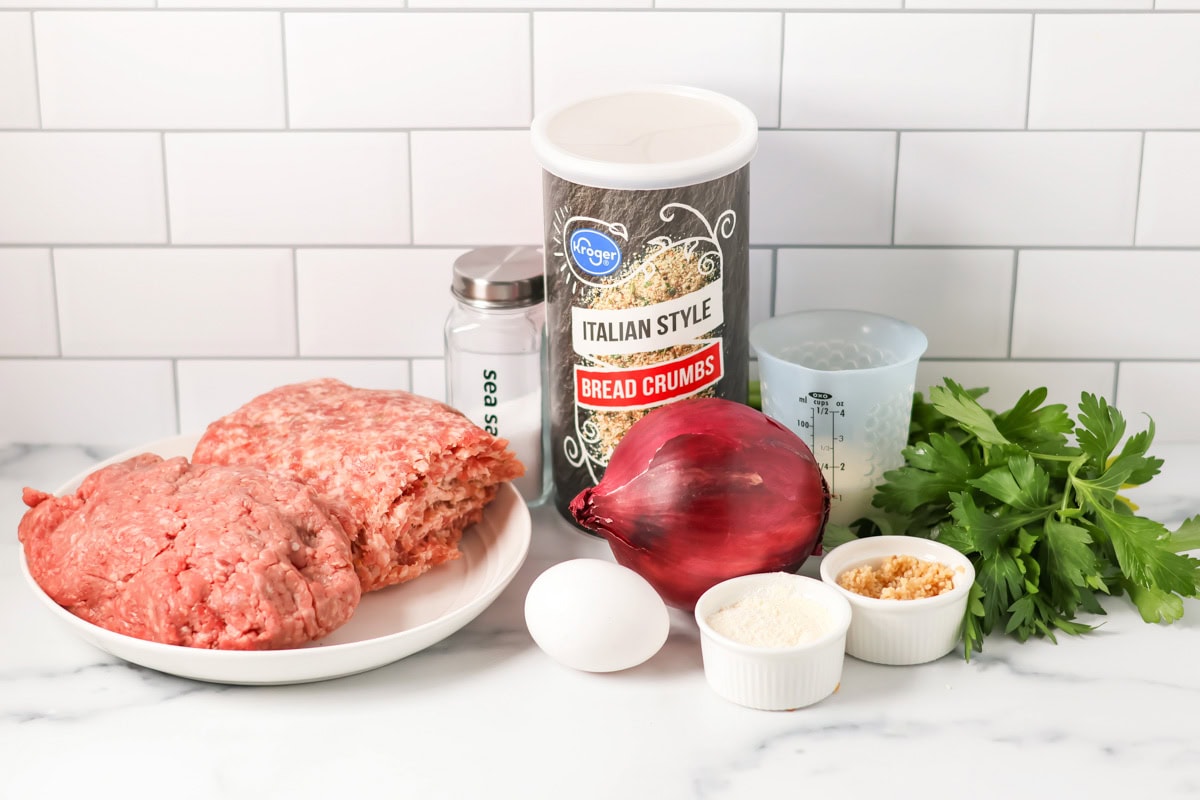 Spaghetti and meatballs is the ultimate, family-friendly comfort food, featuring easy homemade meatballs simmered in a rich tomato sauce! Ingredients for spaghetti and meatballs on a kitchen counter.