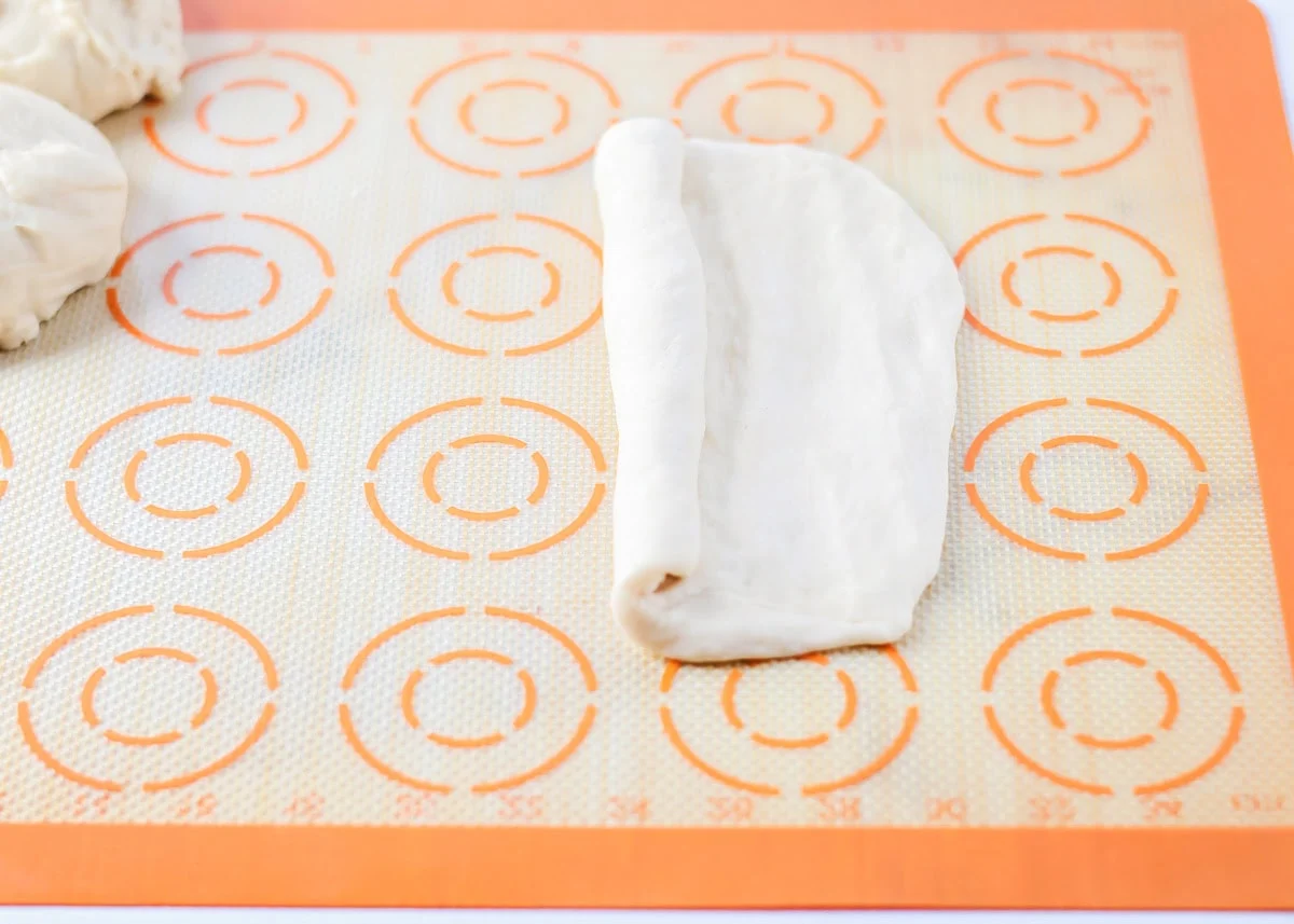 Rolling and shaping dough into loaves.