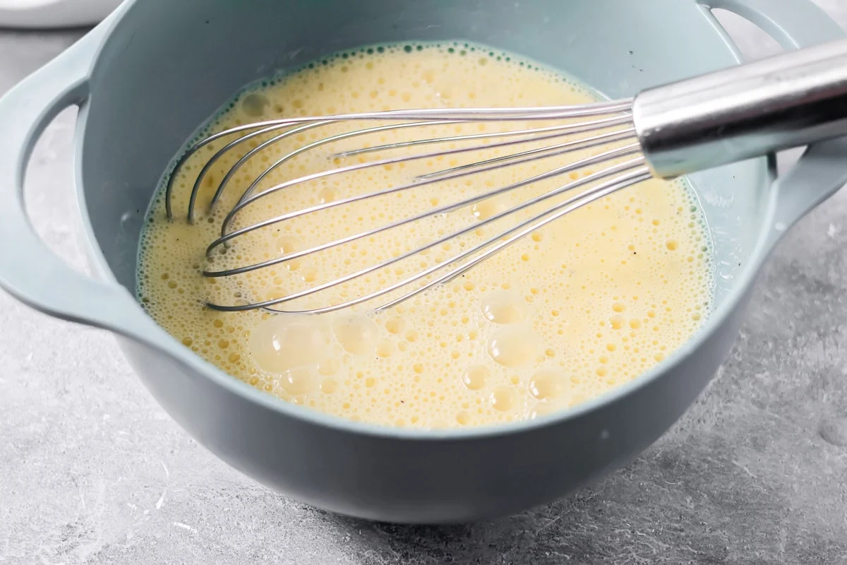 Egg mixture in bowl for quiche recipe.