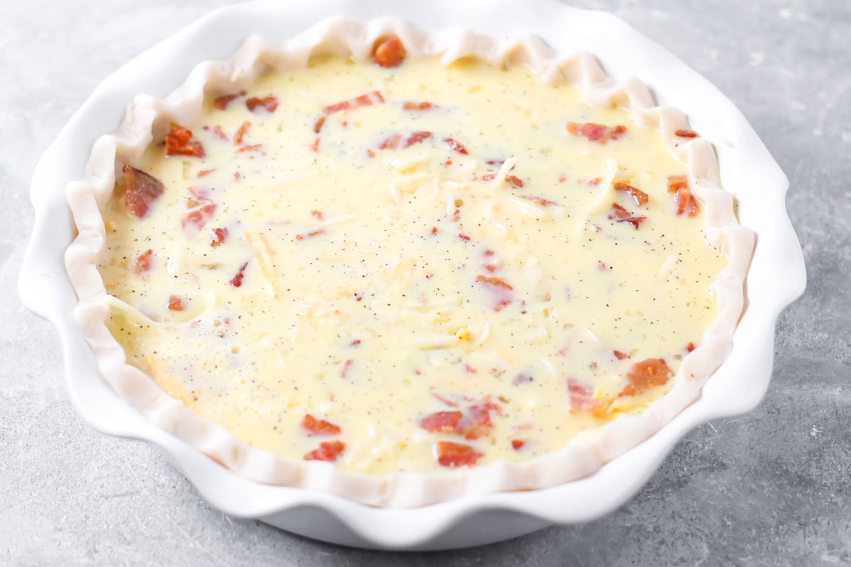 Eggs and ingredients in pie crust.
