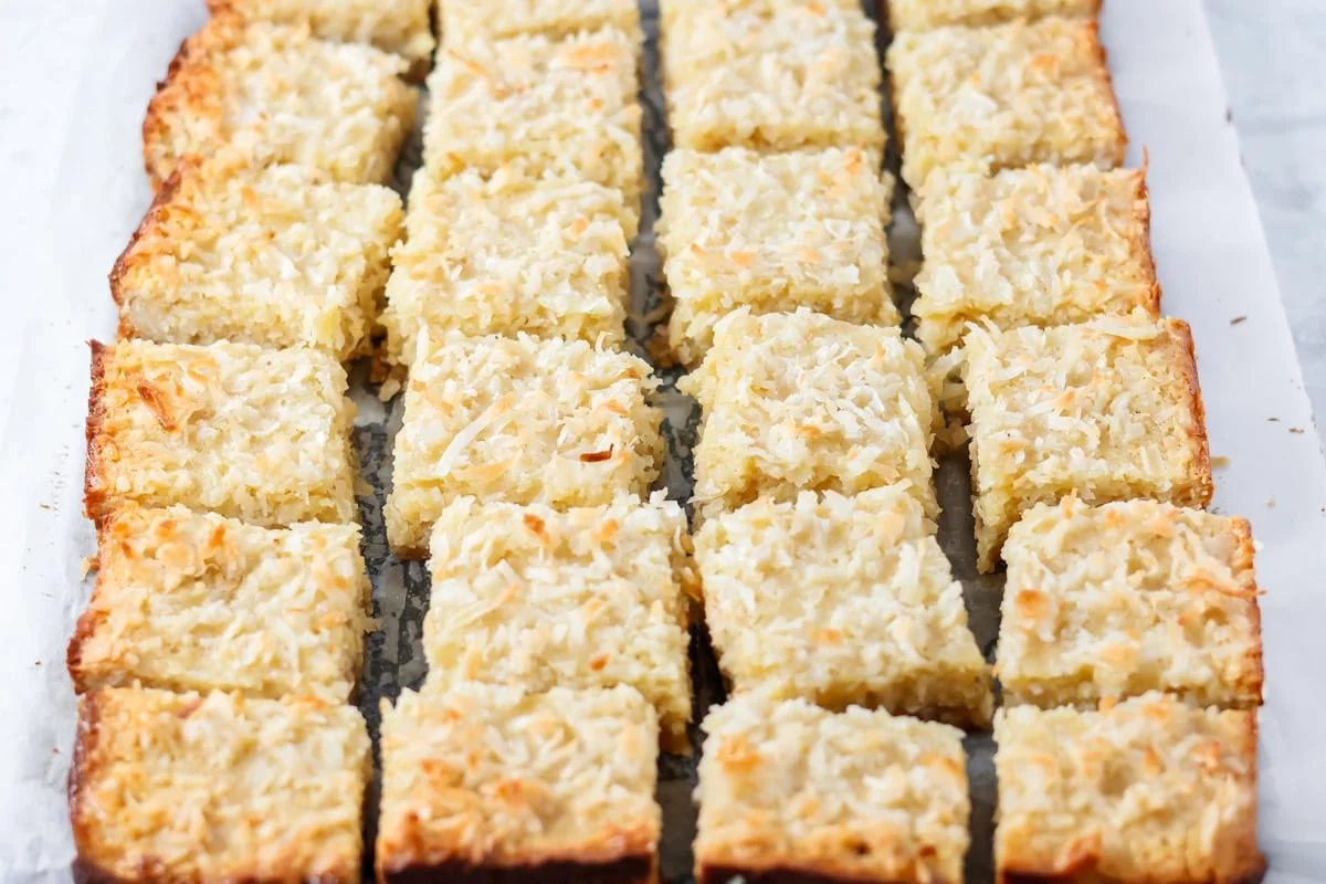 Cut coconut bars on parchment paper.