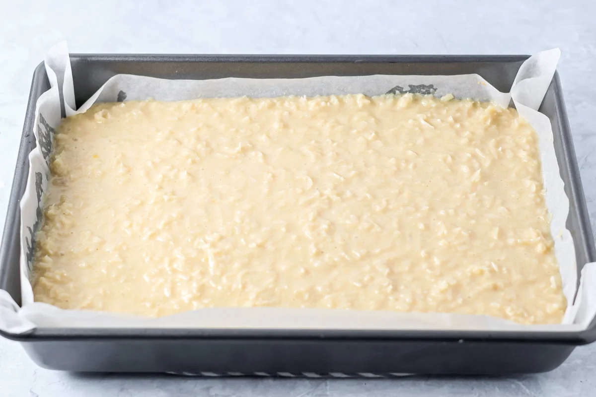 Coconut filling on top of baked shortbread crust.