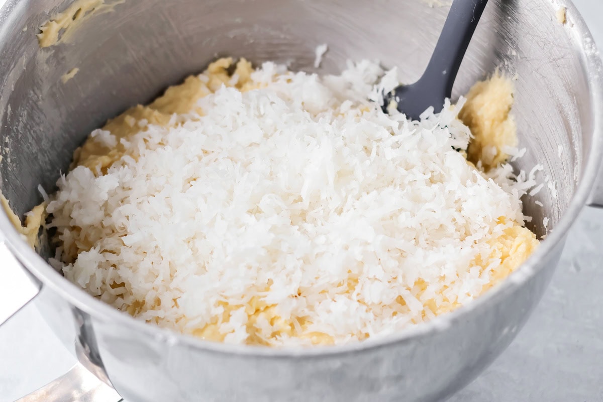 Cupcake batter with coconut in a mixing bowl.