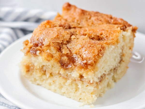 The best coffee cake recipe cut and served on a white plate.